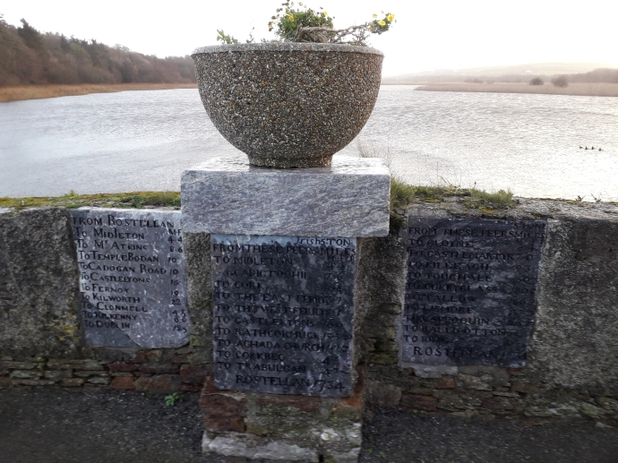 Milestones in place on the bridge at Rostellan, with Rostellan Lake in the background, and the main site of the former pleasure gardens at left (Damian Shiels)